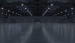BAM Agency A large, empty industrial building with a high ceiling and multiple bright lights echoes the changing landscapes of youth trends. Reflective floors and steel beams contribute to its open, spacious feel, mirroring how spaces can adapt in these dynamic times. BAM Agency