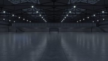 BAM Agency A large, empty industrial building with a high ceiling and multiple bright lights echoes the changing landscapes of youth trends. Reflective floors and steel beams contribute to its open, spacious feel, mirroring how spaces can adapt in these dynamic times. BAM Agency