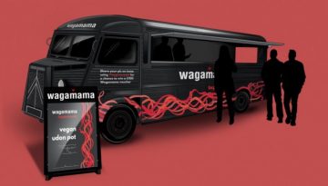 BAM Agency Illustration of a black Wagamama food truck with red accents on a vibrant red background. A sign in front advertises an experiential vegan udon pot, blending flavor and innovation. Three silhouetted people stand nearby, adding to the ambiance of this BAM 2.0 culinary experience. BAM Agency