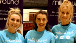 BAM Agency Three people, bright smiles on their faces, don blue Milkround T-shirts as they stand proudly before Milkround banners. Theyre ready to connect freshers with exciting graduate job opportunities against the backdrop of a dark brick wall. BAM Agency