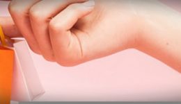 BAM Agency A close-up of a hand, likely belonging to an older millennial, holding several miniature shopping bags in vibrant colors like yellow and white against a soft pink background. The scene exudes a playful and stylish vibe, perfect for eye-catching marketing campaigns. BAM Agency