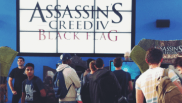 BAM Agency A group of people gathered in front of a display promoting Assassins Creed IV: Black Flag. The backdrop features the games logo on a large screen, crafted to be awesome by innovative student marketing. Some individuals are captivated by the display, while others casually walk by. BAM Agency