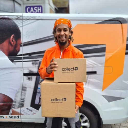 A smiling delivery driver in an orange jacket and bandana holds two Collect+ parcels in front of a branded delivery van. BAM Agency