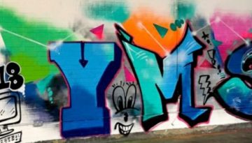 BAM Agency A vibrant graffiti mural on a white brick wall celebrates the YMS London 2018 event highlights. The artwork features animated letters YMS in bold colors: blue, orange, and pink, with dynamic designs and playful faces. The left side includes cartoon-style doodles of a computer, cityscape, and clouds. BAM Agency