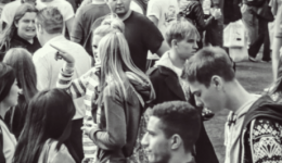 BAM Agency A black and white photo captures a bustling outdoor scene, filled with students weaving through the crowd. Many converse, while others focus on their own paths. Casual attire dominates this re-vamped gathering of dynamic individuals. BAM Agency