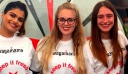 BAM Agency Five people stand in a line, smiling at the camera. Four are wearing white wagamama shirts, while the person on the right sports black. The scene captures a vibrant moment from the Freshers Tour with a wagamama logo visible on the top right. BAM Agency