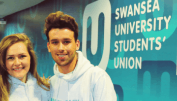 BAM Agency Three people in white hoodies stand smiling before a wall that reads Swansea University Students Union and its Welsh translation. The background boasts a modern, colorful design, showcasing the vibrant spirit of Student Ambassadors representing their university brand. BAM Agency