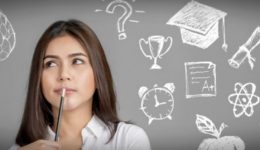 BAM Agency A woman holds a pen to her chin, appearing thoughtful. Surrounding her are chalk drawings on a gray background, including a brain, light bulb, and graduation cap—symbols of important facts every student should know. BAM Agency