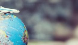 BAM Agency A small toy airplane sits atop a globe, symbolizing the 2020 travel trends or exploration. The detailed continents and oceans glow in focus while the world blurs behind, capturing a vision that speaks to the adventurous youth market. BAM Agency