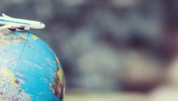 BAM Agency A small toy airplane sits atop a globe, symbolizing the 2020 travel trends or exploration. The detailed continents and oceans glow in focus while the world blurs behind, capturing a vision that speaks to the adventurous youth market. BAM Agency